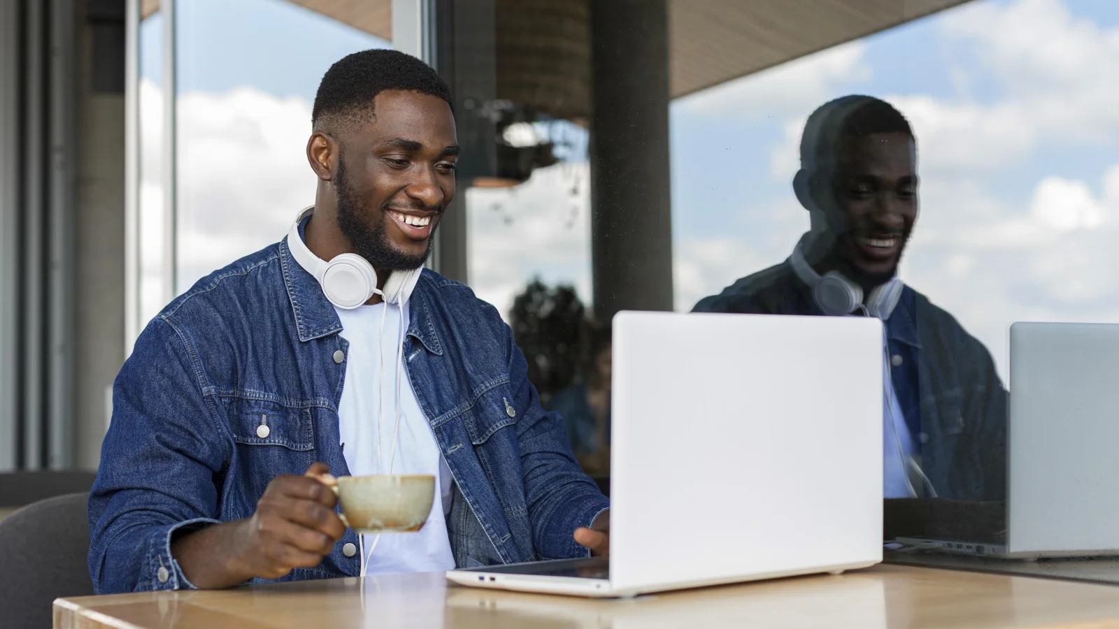 A professional organising business records at a laptop